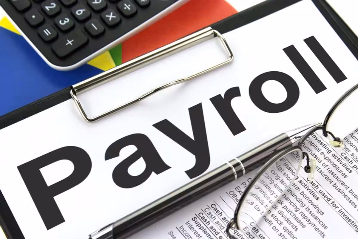 payroll file, glasses and pen