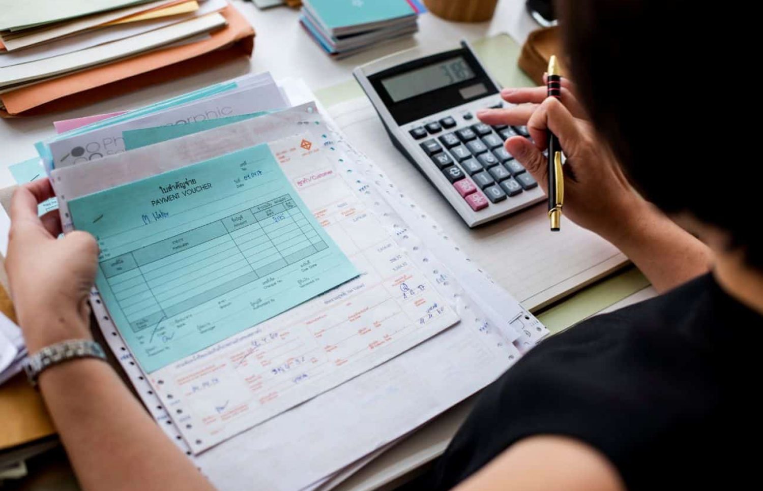 An accountant woman making calculations on a calculator